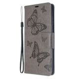 Peňaženkové kožené puzdro Embossing Two Butterflies na Samsung Galaxy A71 - Sivá